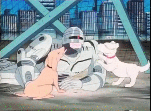 Trecho da animação de Robocop, em que ele está deitado no chão e dois cachorros o cheiram e lambem, felizes.